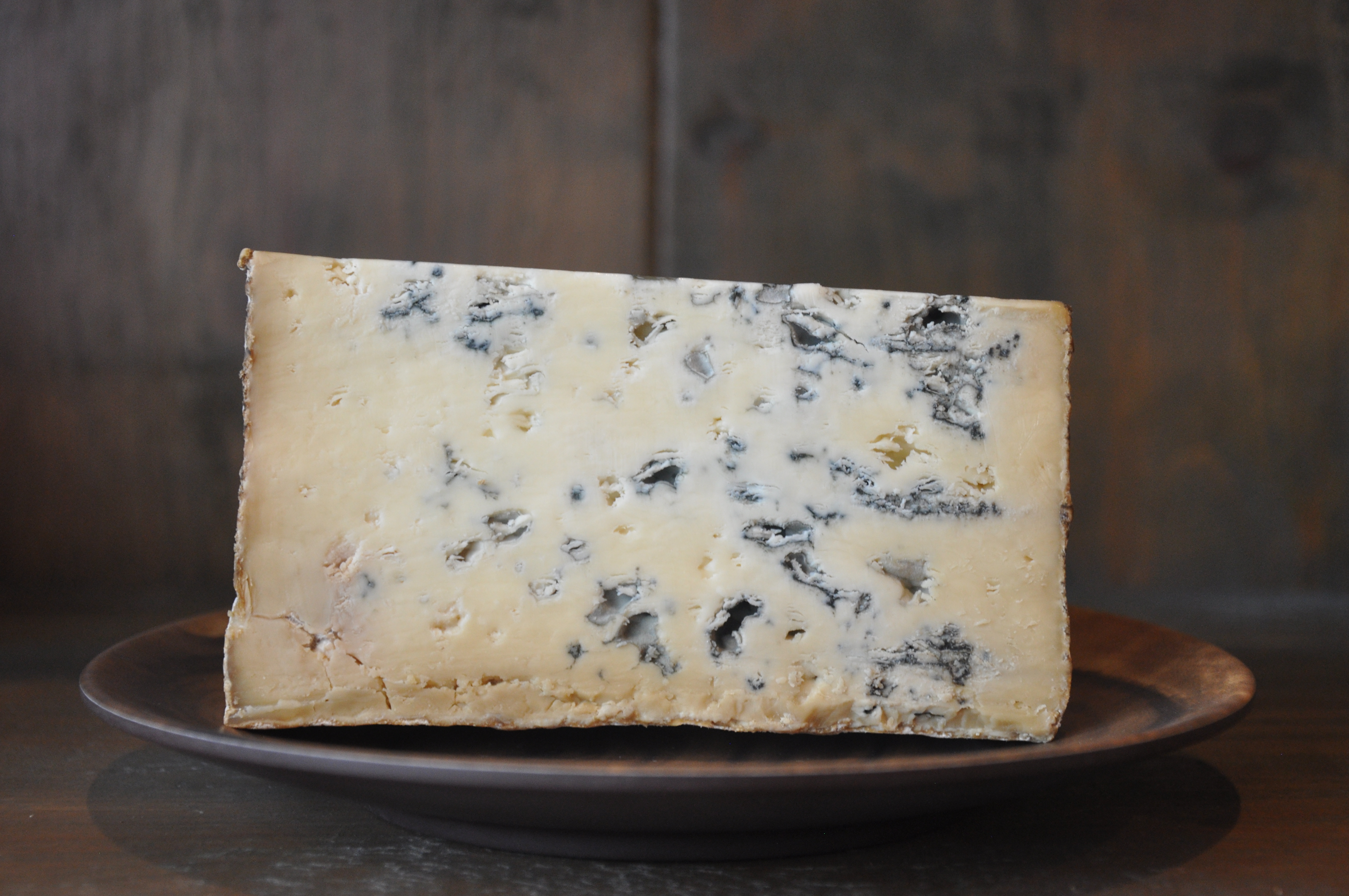 Wedge of Bayley Hazen Blue cheese cut open on a slate board